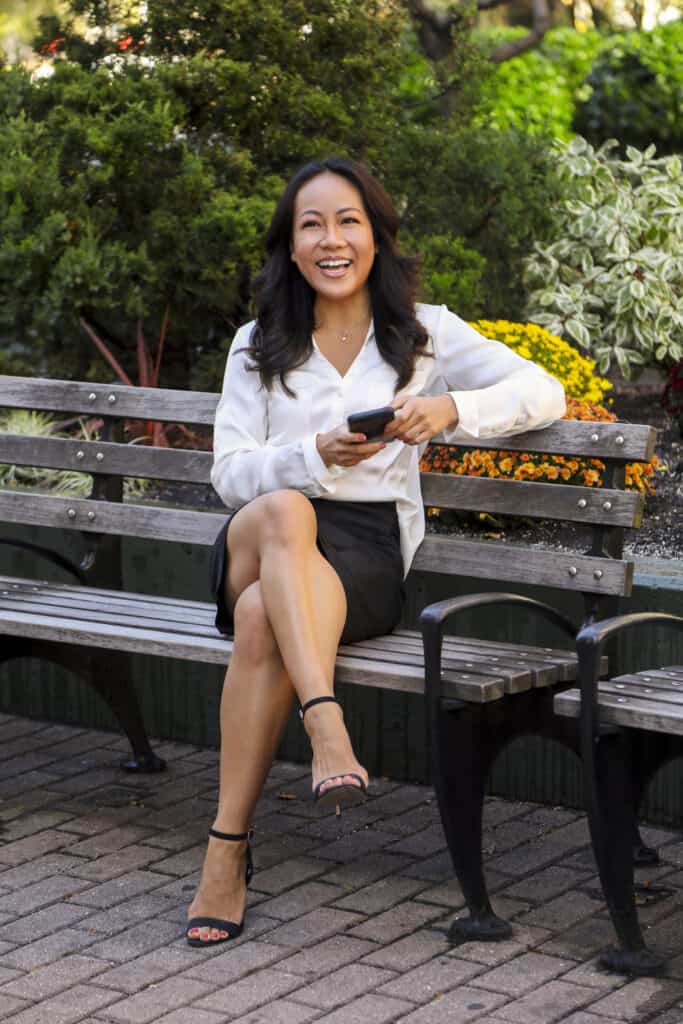 Christine Lee Asian woman on phone bench